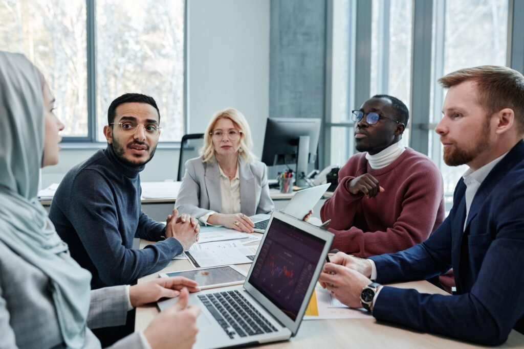 Five people sitting on a table and making a business decision